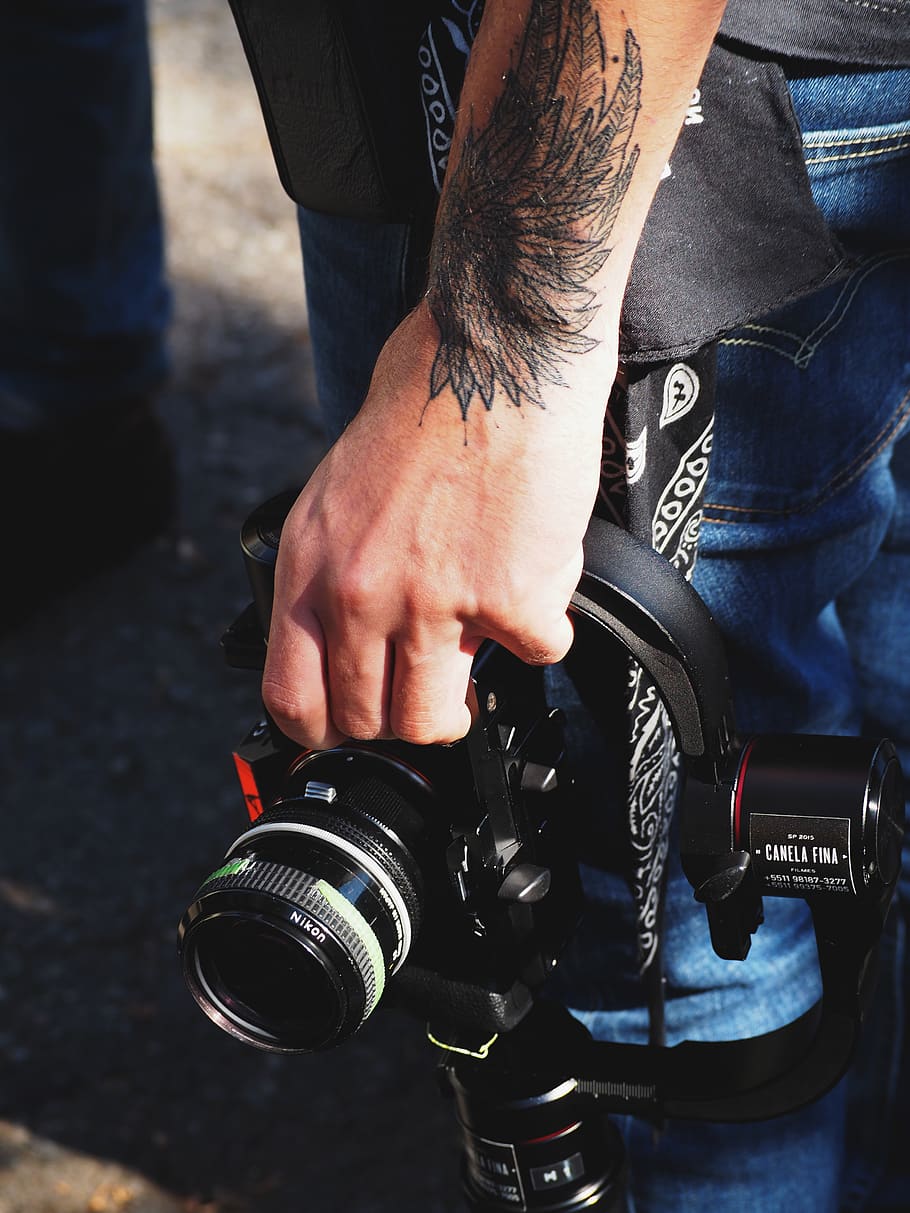 Reflex camera tattoo on the upper arm.
