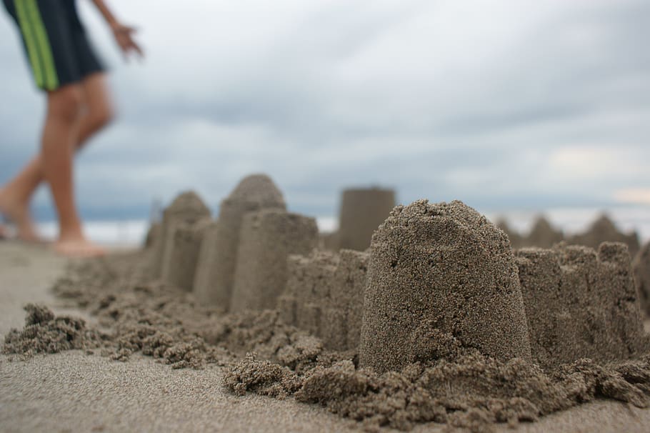 Person Standing Near Sand Castle, beach, seashore, land, sky HD wallpaper