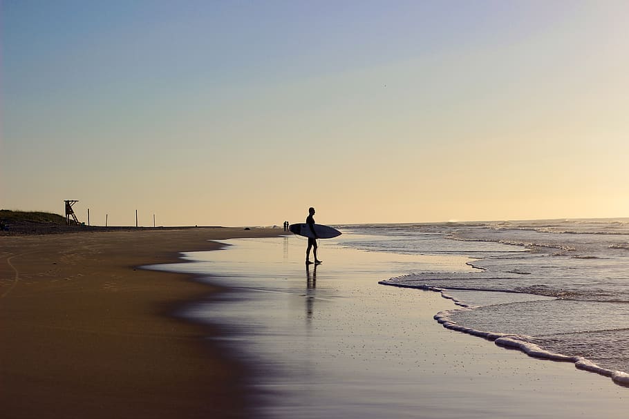 Person Holding Surfboard On Shore, beach, brazil, campeche, dawn, HD wallpaper