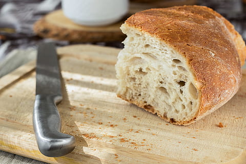 Sliced Bread and Stainless Steel Knife on Top of Brown Wooden Chopping Board HD wallpaper