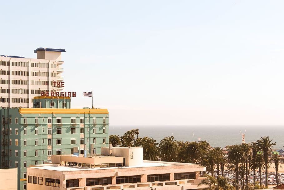 beach, hotel, yellow, sky, pier, palm trees, american flag HD wallpaper