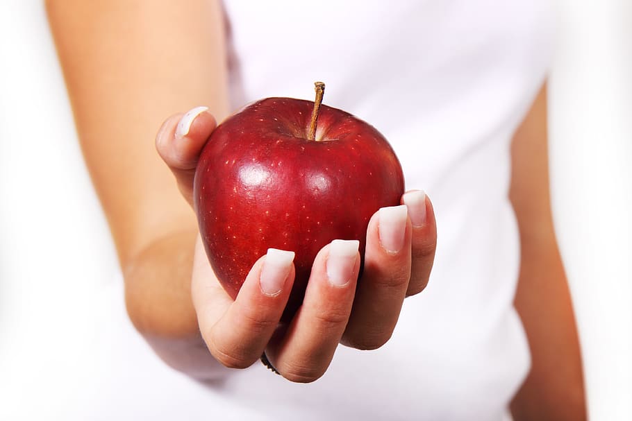 Person in White Shirt Holding Red Apple, food, fruit, hand, healthy HD wallpaper