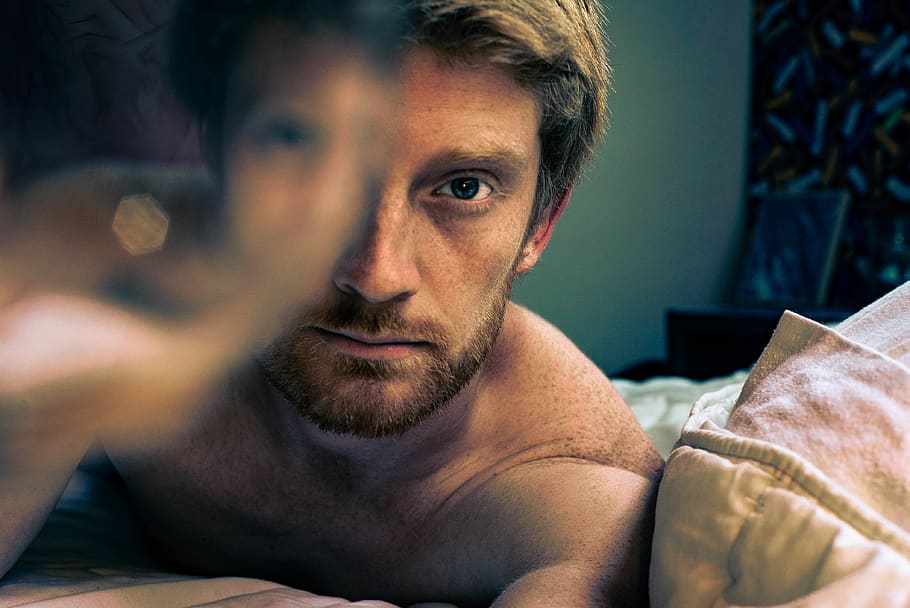 man lying on bed, beard, facial hair, portrait, one person, headshot HD wallpaper