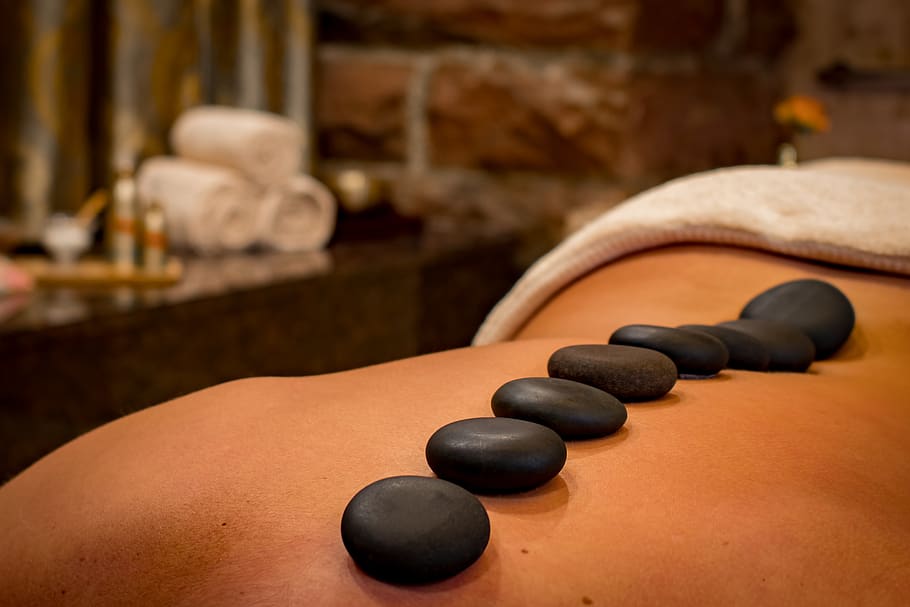 Premium Photo | Spa, beauty treatment and wellness background with massage  stone, orchid flowers, towels and burning