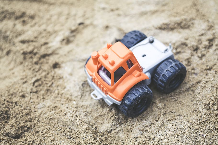 Orange and Gray Plastic Truck Toy on Sand, daytime, ground, little HD wallpaper