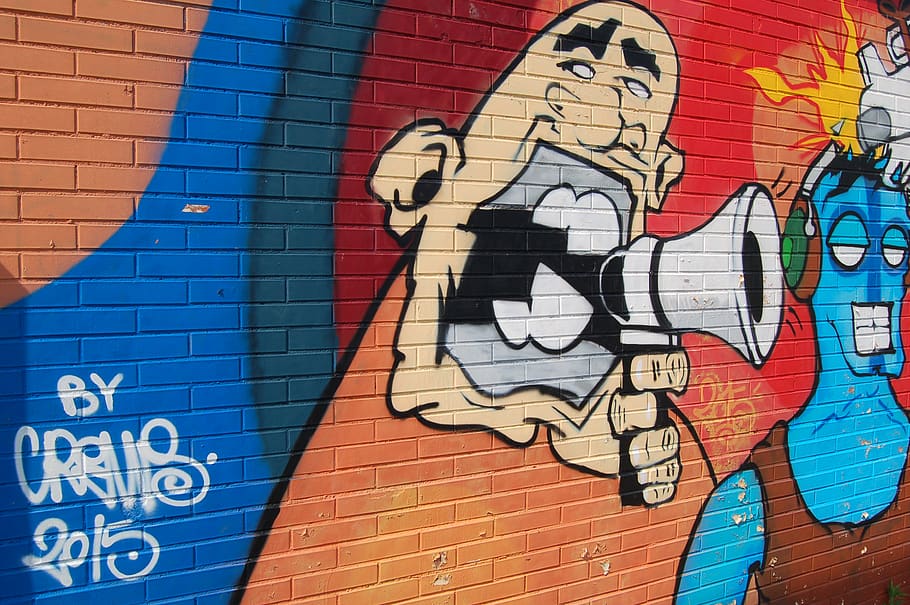 A large caricature holding a megaphone, painted on a brick wall., HD wallpaper