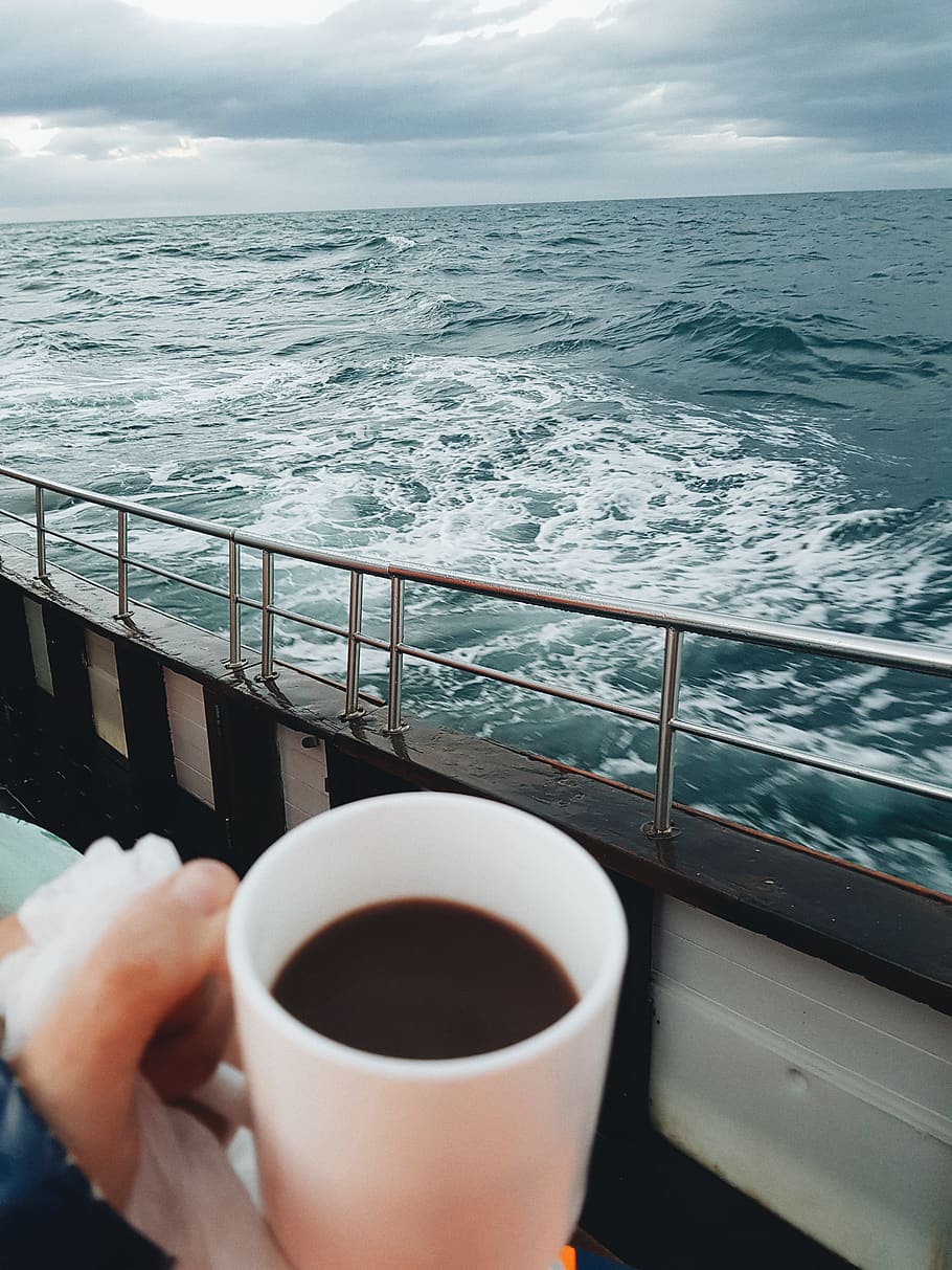 black liquid filled mug, sea, water, one person, human hand, real people HD wallpaper