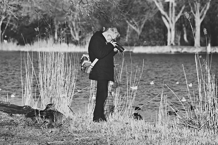 man, photographer, standing, checking camera, bag, river bank HD wallpaper