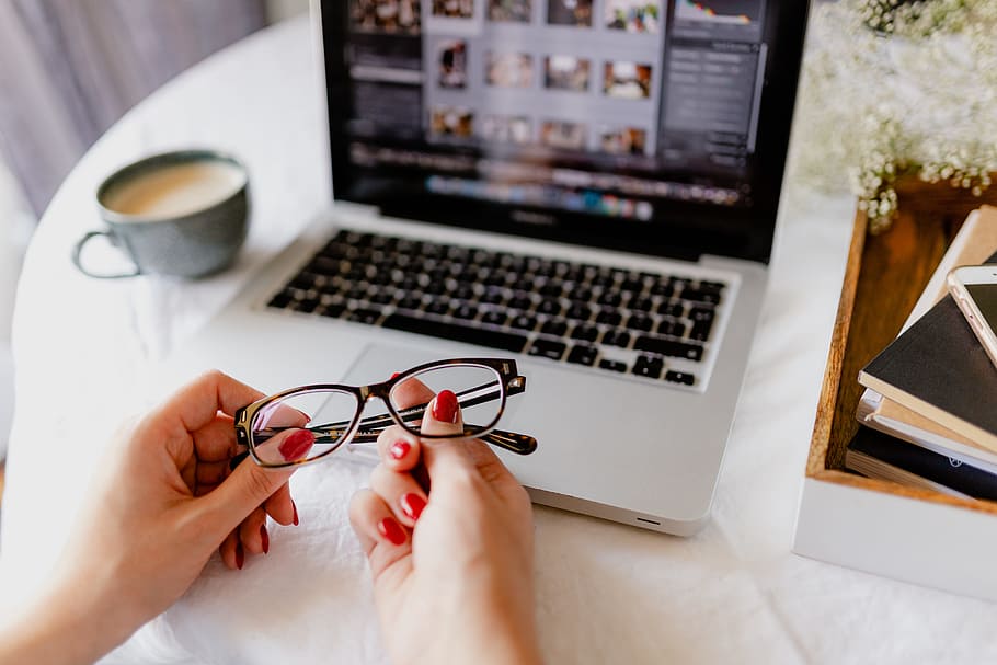 A woman works at a desk with a laptop and a cup of coffee, macbook HD wallpaper