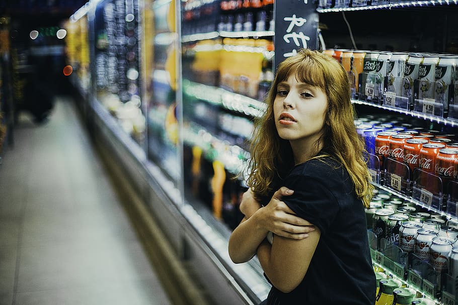 Photo of a Woman Standing Near Beverage Coolers, adult, attractive