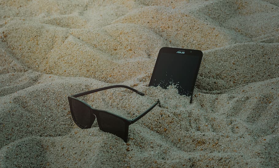 Photo of Phone and Sunglasses on Sand, blur, cellphone, close-up HD wallpaper