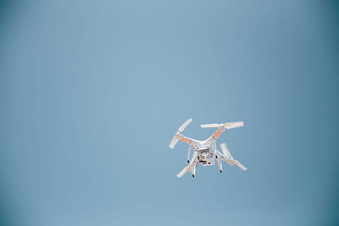 A drone in flight with clear sky in the background, clouds, control HD wallpaper