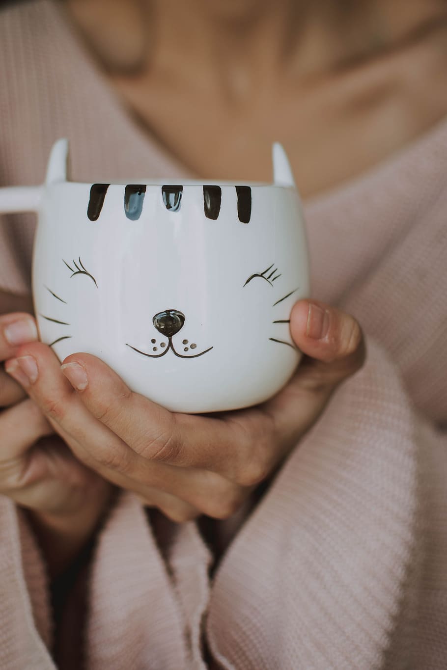 person holding white and black cat graphic teacup, hand, sweater HD wallpaper