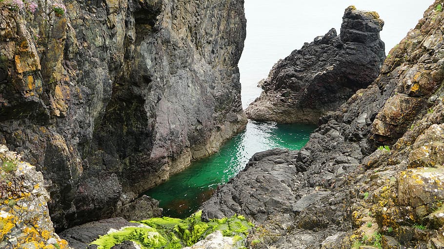 Top View of Rock Cliffs in Body of Watrer, coast, coastline, daylight HD wallpaper