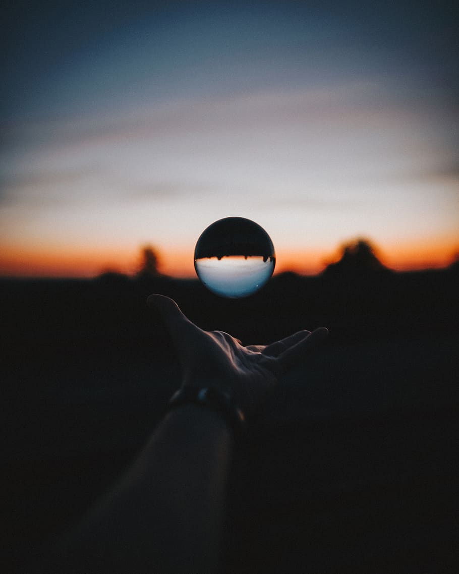 Force Perspective Photography of Sphere Glass during Sunset, action HD wallpaper