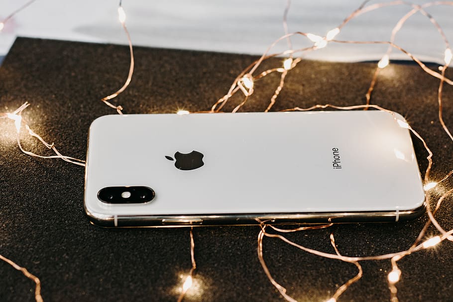 Close-Up Photo Of iPhone Near String Lights, camera, cellphone HD wallpaper