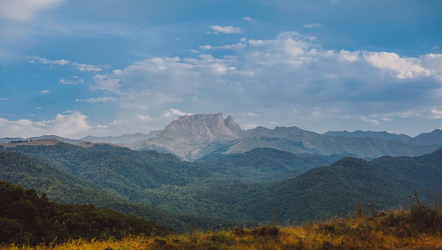 Green Forest With Brown Rock Formation Background, clouds, daylight HD wallpaper