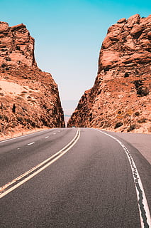 road in between on rock formation, cliff, canyon, desert, orange HD wallpaper
