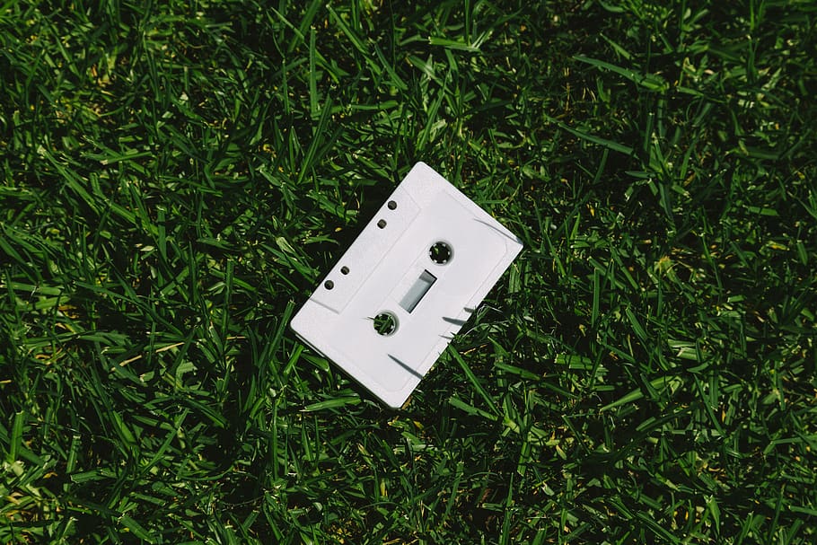 White Cassette Tape On Grass, audio, ground, lawn, plant, green color HD wallpaper