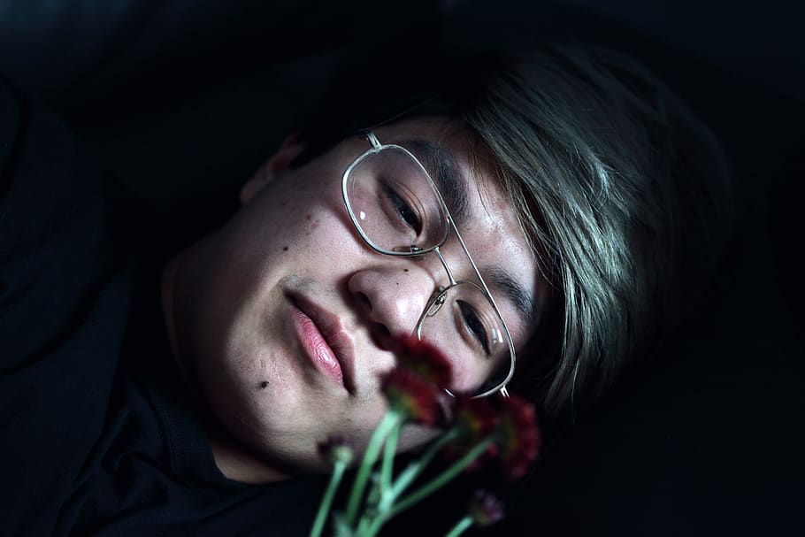 Man Holding Red-petaled Flowers, close-up, dark, emotion, equality HD wallpaper