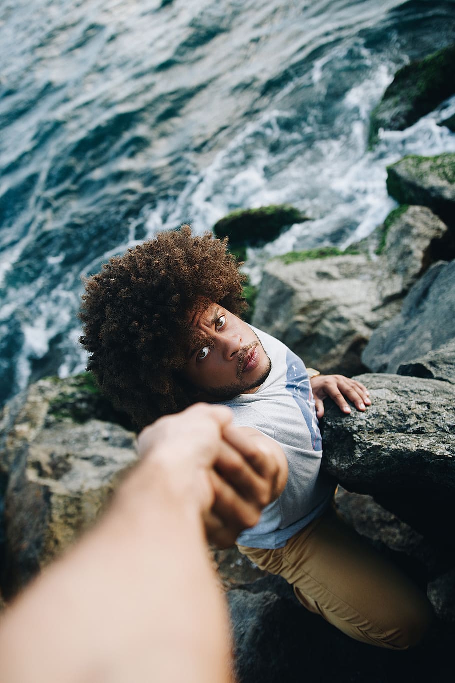 Man in White Shirt Holding Rock Formation, afro, beach, boulders HD wallpaper