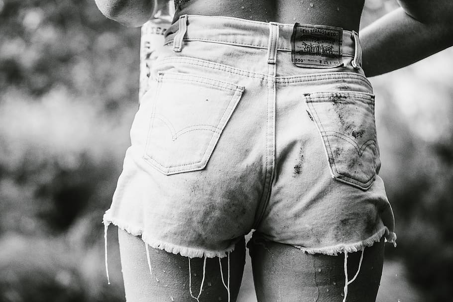 person wearing denim short-shorts in grayscale photography, clothing