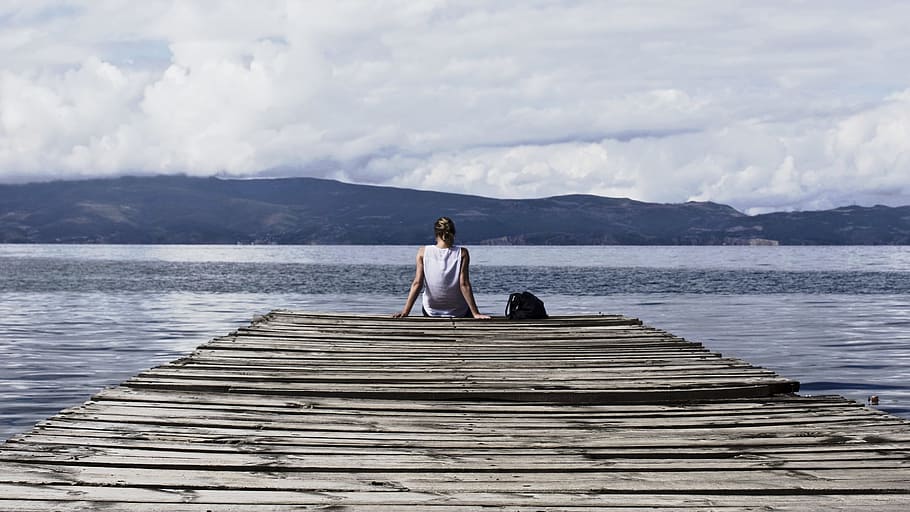 Person Sitting on Brown Wooden Dock Under Cloudy Blue Sky, clouds HD wallpaper