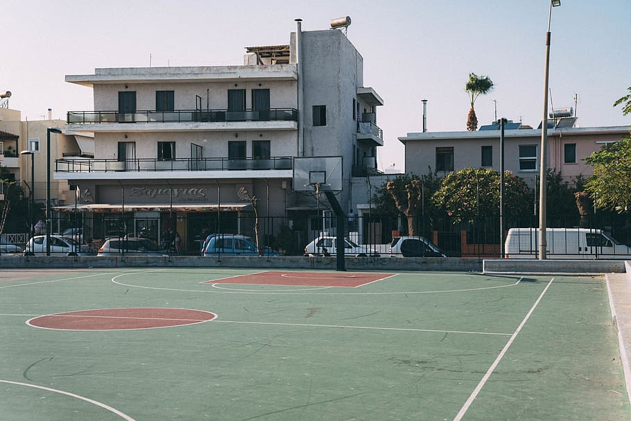 basketball court near building during daytime, human, person
