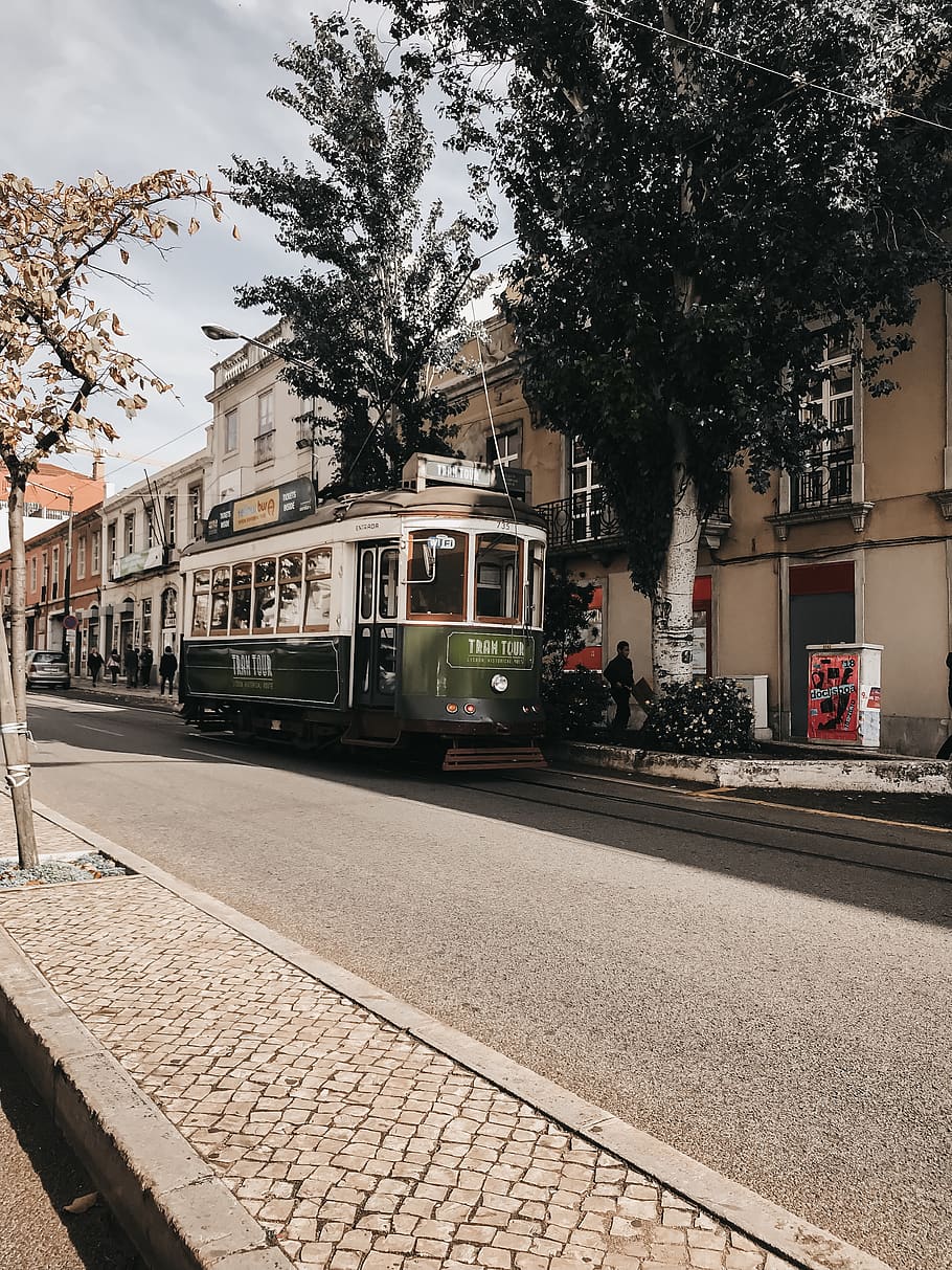 Green Tram Near Brown Building, architecture, buildings, commute HD wallpaper
