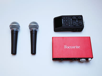 red Focusrite audio interface and two black dynamic microphones HD wallpaper