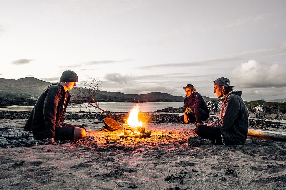 three men in front of bonfire, person, beach, shore, coast, outdoors HD wallpaper