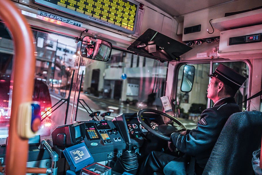 Man Driving Bus, blur, buildings, city, commuter, driver, inside HD wallpaper