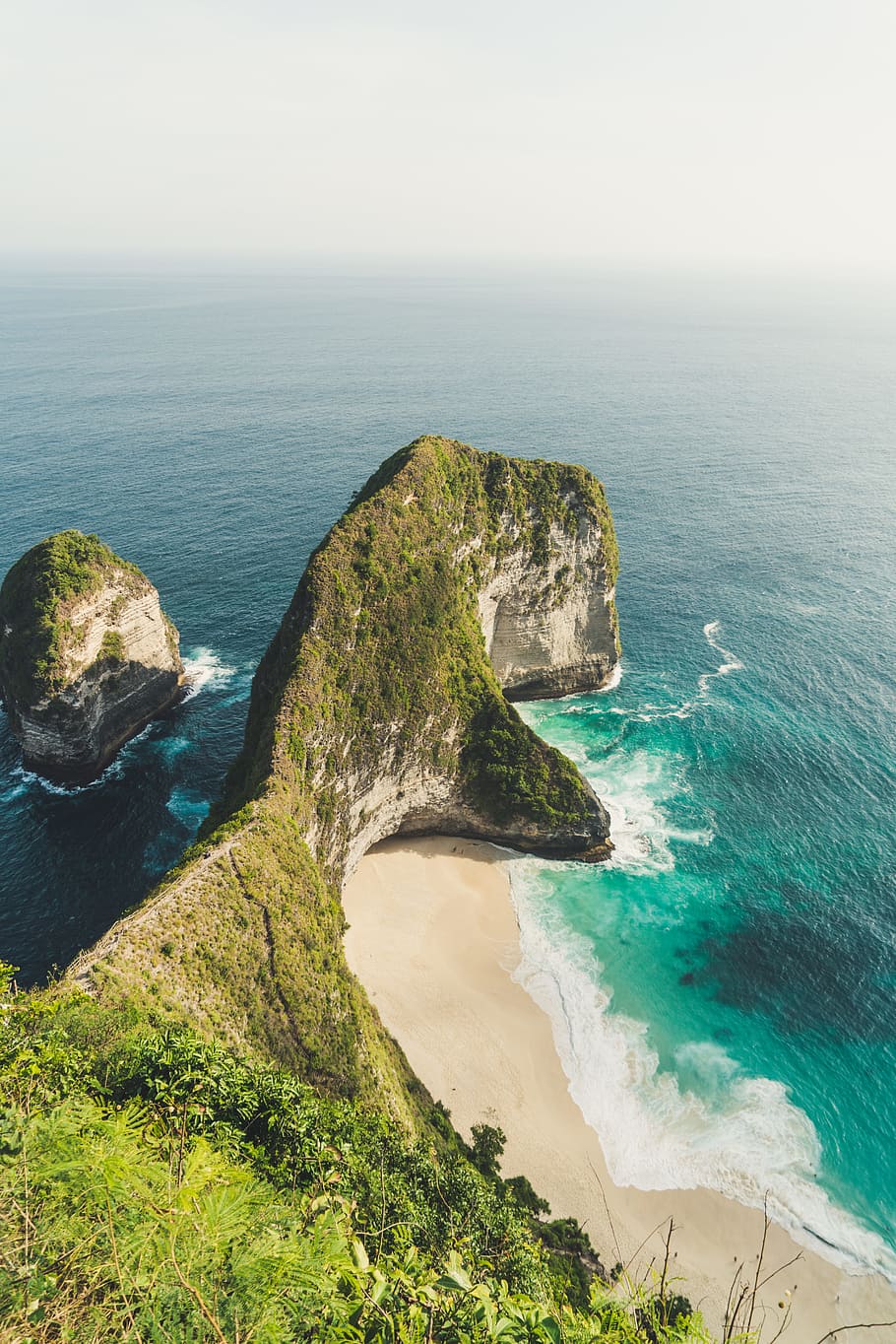 rock formation beside ocean under white clouds during daytime HD wallpaper