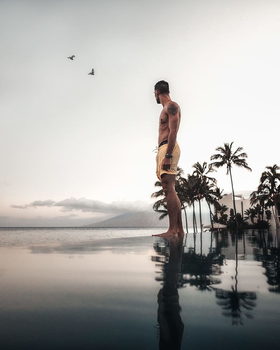 person standing on body of water reflecting on water, pool, beach HD wallpaper