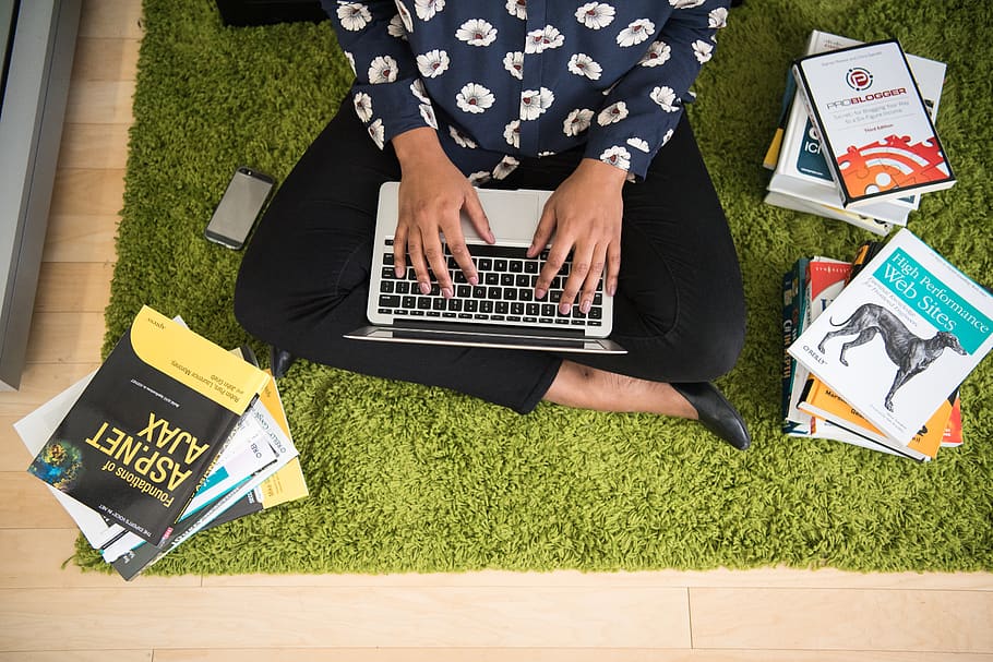 Person Holding Macbook Flatray Photograph, books, carpet, cellphone HD wallpaper