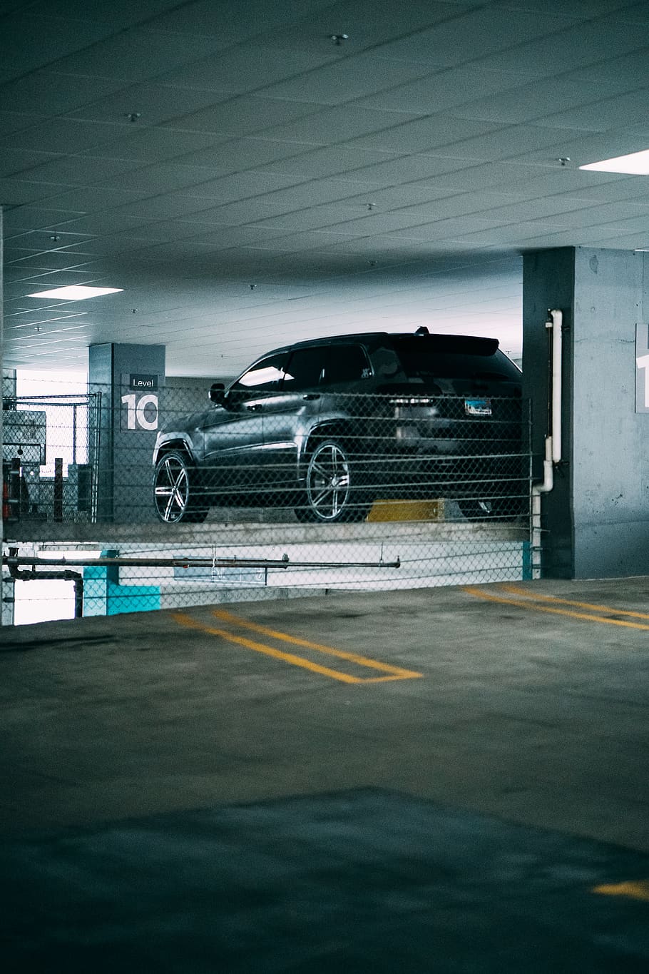HD wallpaper: Black Car on Garage, building, empty, parked car, parking lot