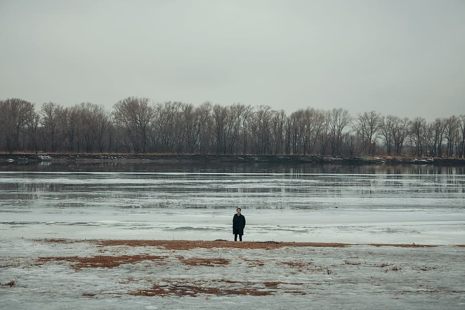 Person Standing Near Body of Water, clouds, cold, daylight, environment HD wallpaper