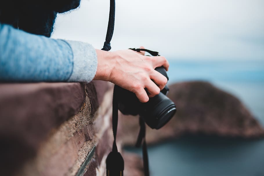 person-holding-black-dslr-camera.jpg