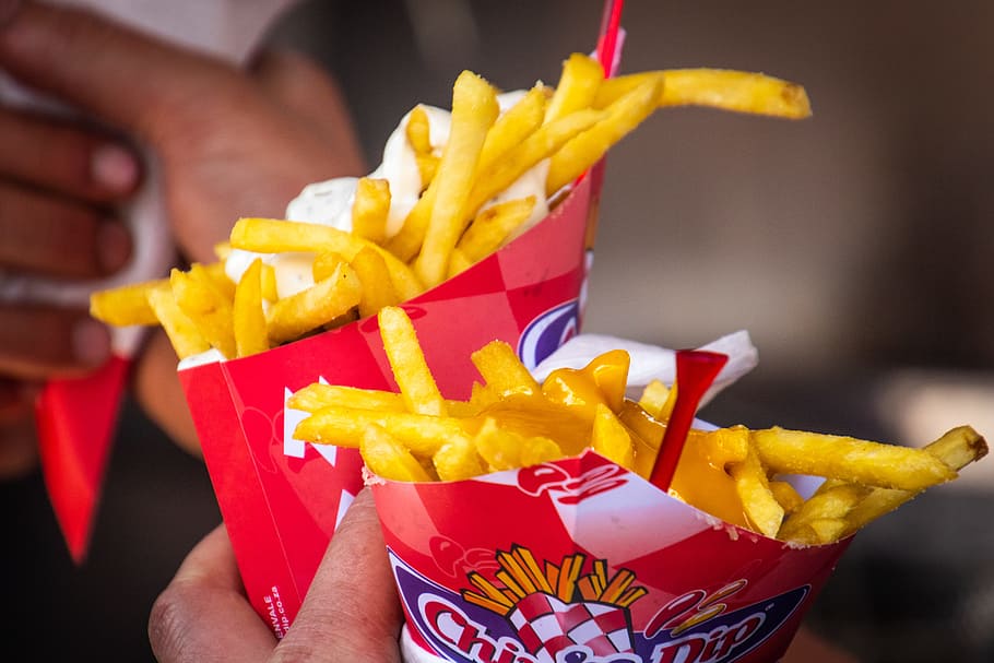 Person Holding Two Potato Fries Packs, bright, cheese, close-up HD wallpaper
