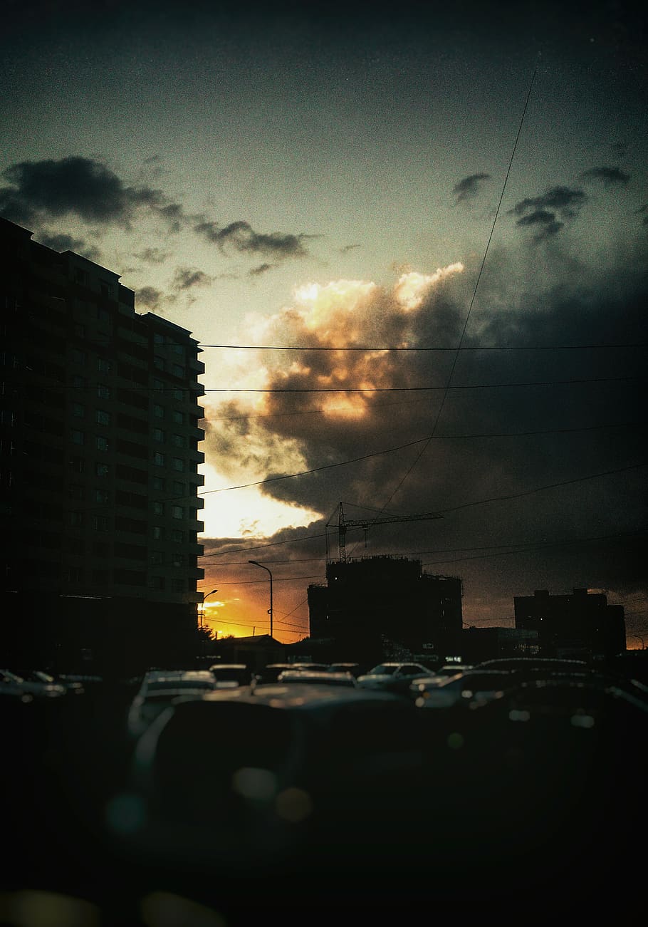 sunset, city, building, clouds, dark, dark clouds, architecture HD wallpaper