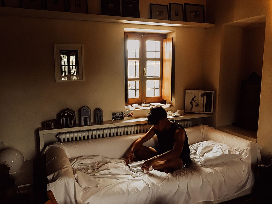 man sitting on bed beside opened window, furniture, bedroom, domestic room HD wallpaper