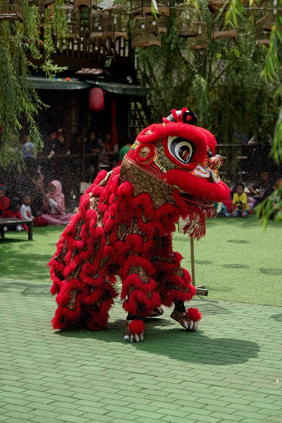 red Chinese lion costume, animal representation, day, art and craft