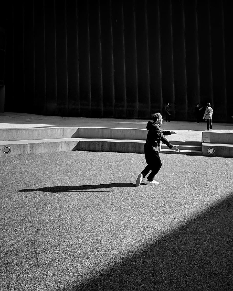 grayscale picture of a man in a hoodie, person, sunlight, shadow HD wallpaper