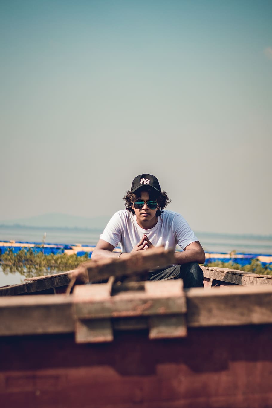 Man Sitting on Boat Near Green Plants, beach, cap, daylight, landscape HD wallpaper
