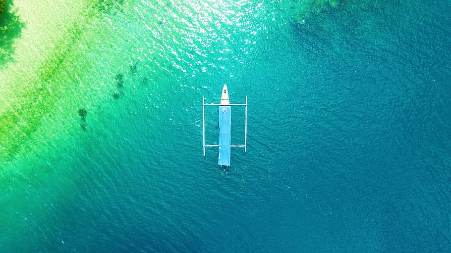White Boat on Calm Body of Water, aerial shot, beach, color, drone shot