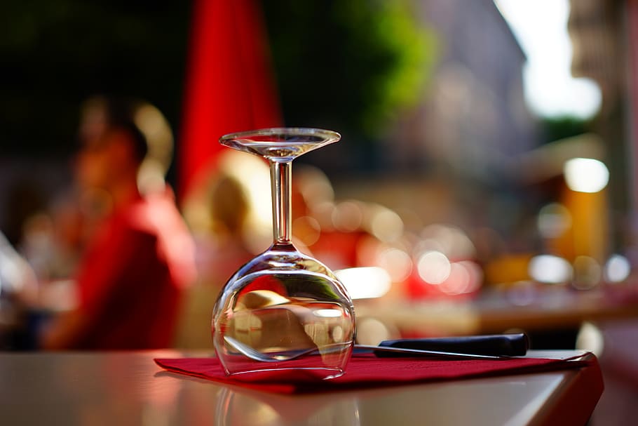 Clear Wine Glass on Top of Brown Table, bar, blur, close-up, cutlery