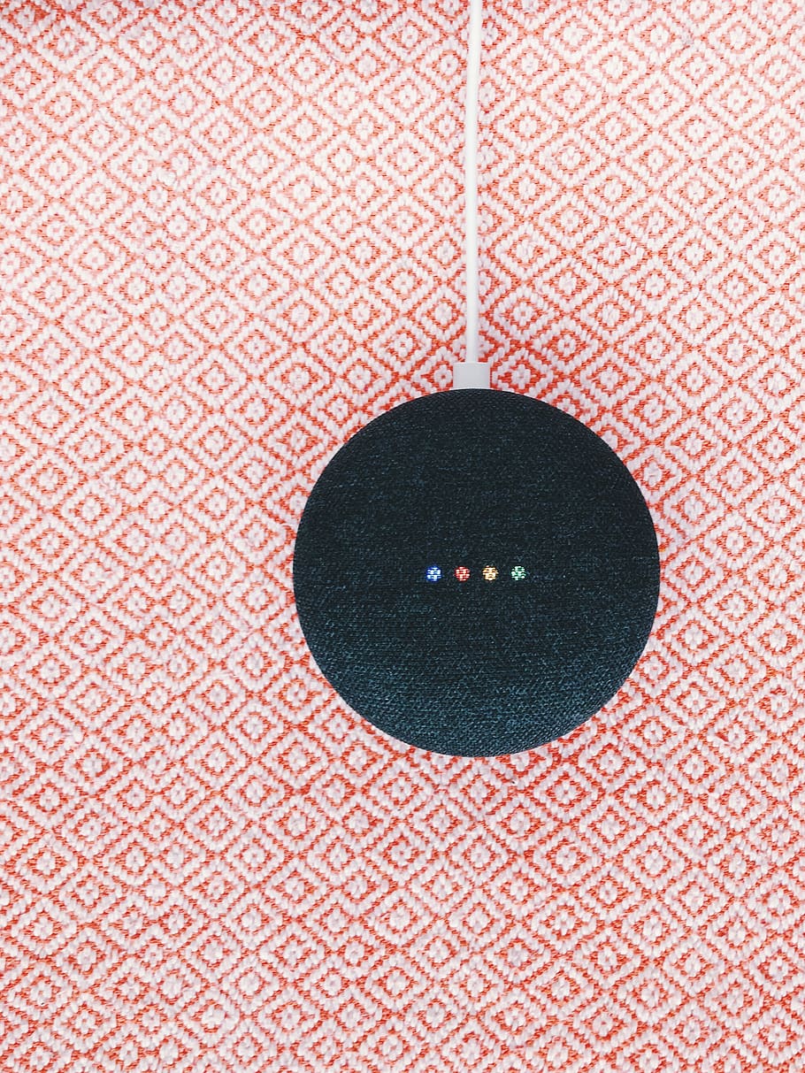 black Google Home Mini on pink textile, rug, pattern, texture