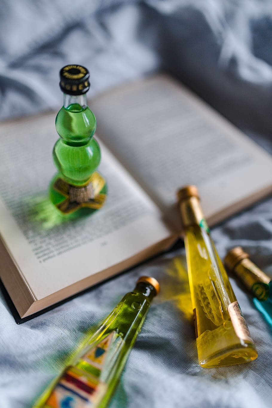 Group of colorful little bottles with liqueurs, book, drink, read, HD wallpaper