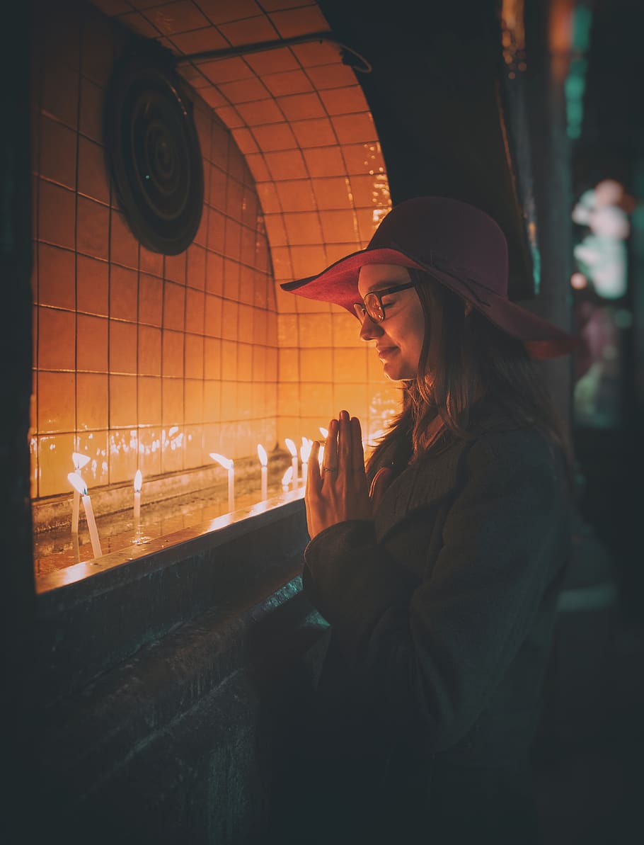 Woman Praying In Front of Lit Candles, candlelight, dark, eyewear, HD wallpaper