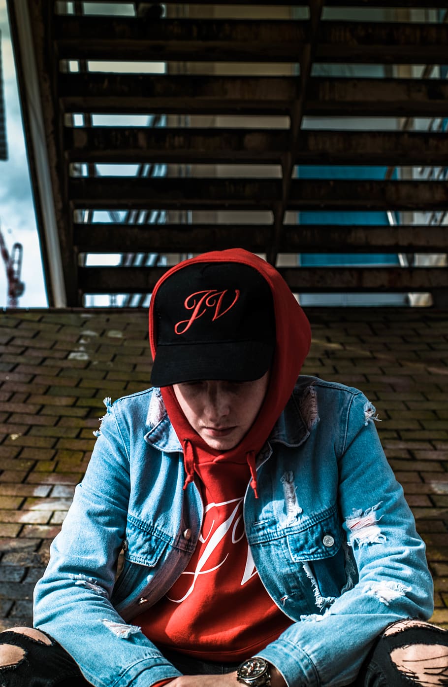 man sits under stairs, clothing, apparel, person, human, hat HD wallpaper